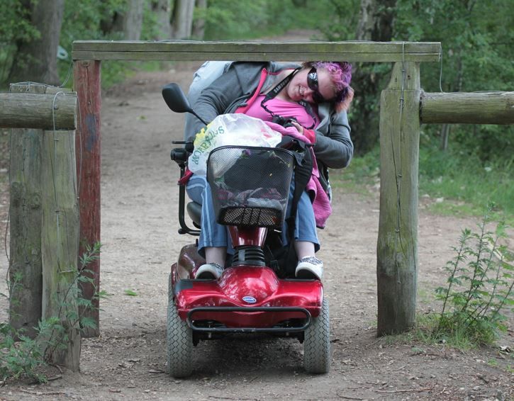 Frau im Rollstuhl hat Schwierigkeiten mit einer Wegsperre