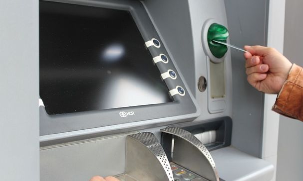 EC-Karte wird in Geldautomat geschoben.