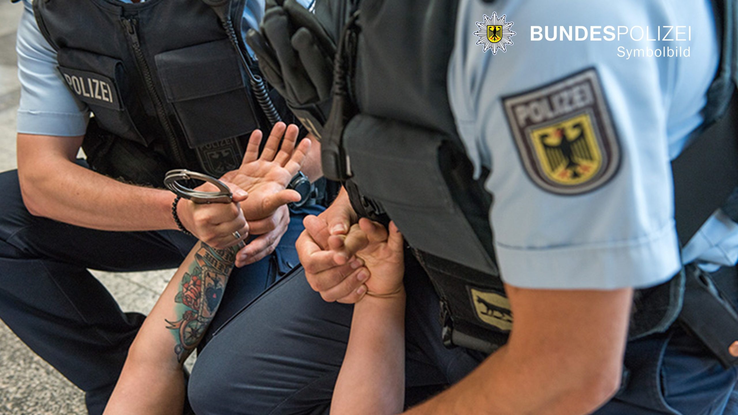 Bundespolizisten legen am Boden liegenden Mann Handschellen an. Symbolfoto Bundespolizei